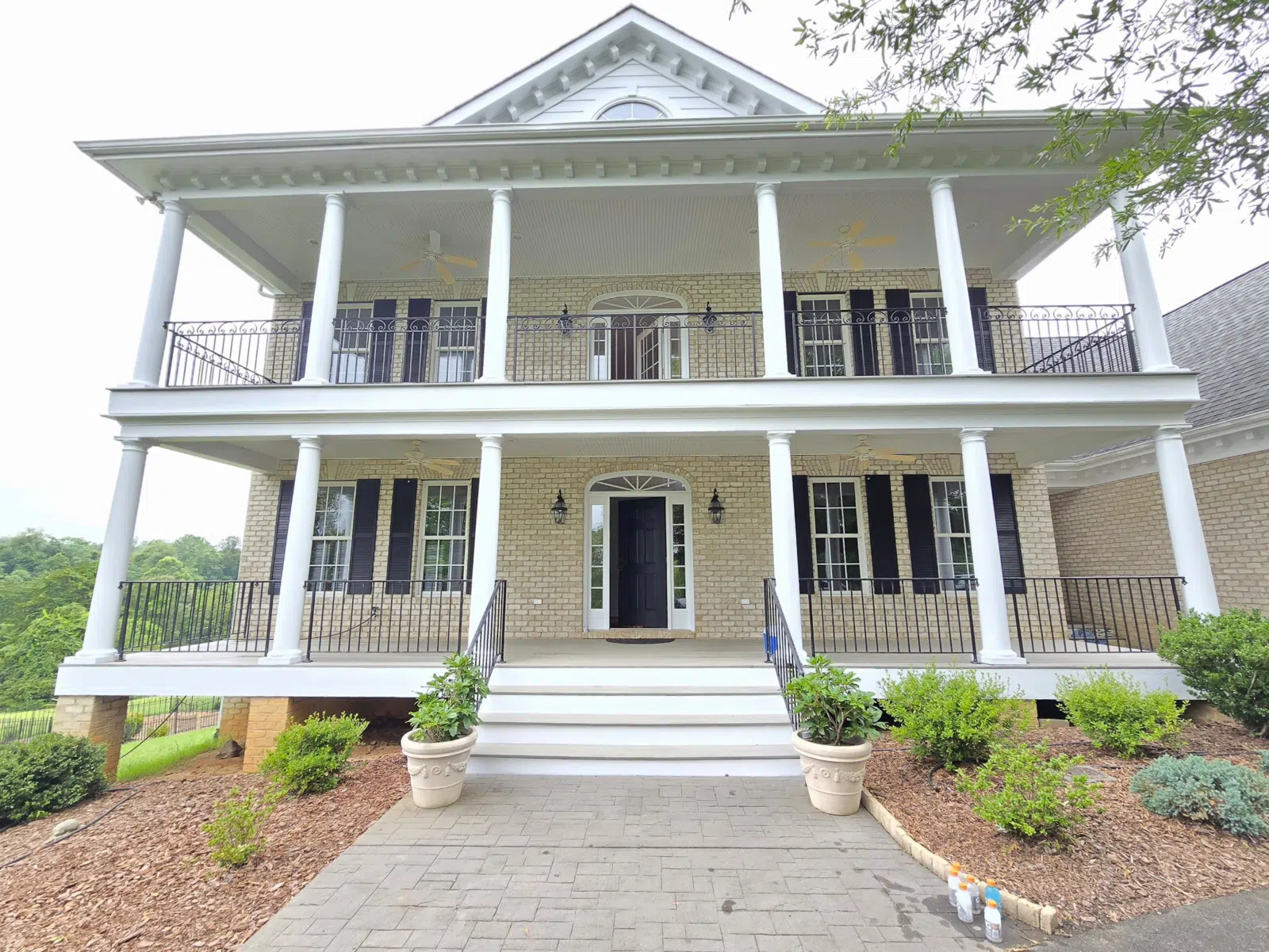 Two-story brick house with white columned porch and balcony — Alvarez' Painting in Charlottesville