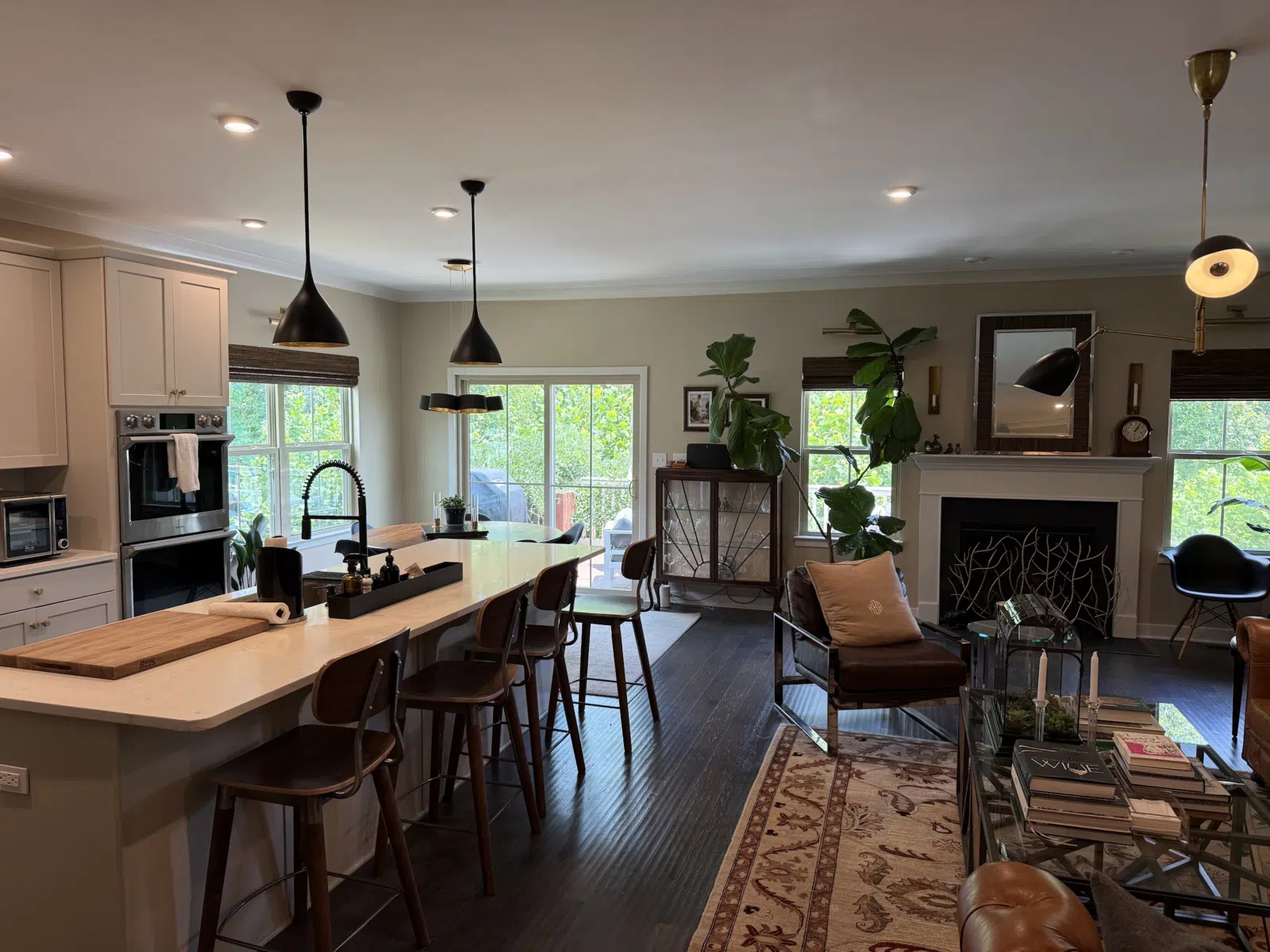 Renovated open kitchen and living room with pendant lights — Alvarez' Painting in Charlottesville